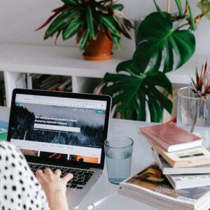 Person Using Macbook Pro on Table